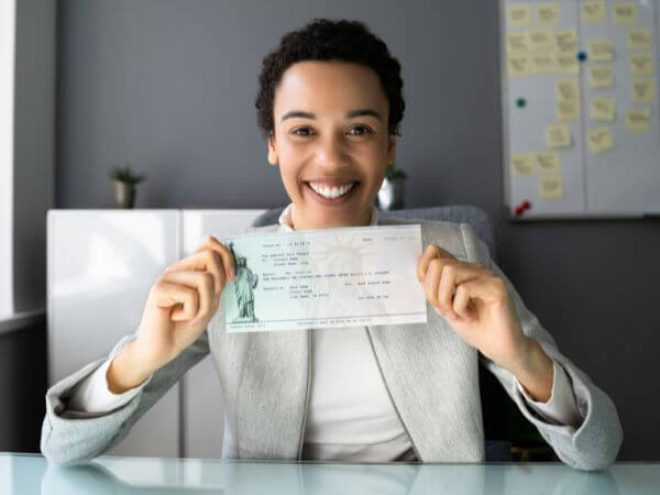 Employee holding up paycheck