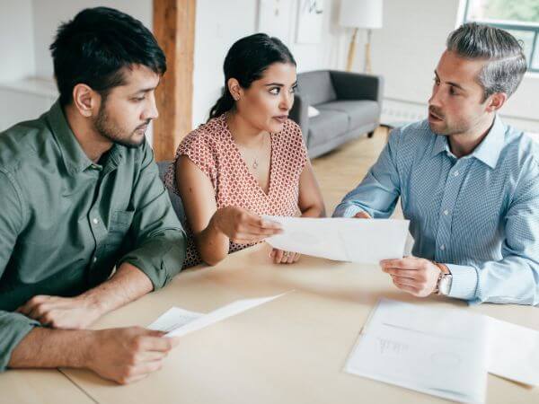 Employees discussing their benefits enrollment system