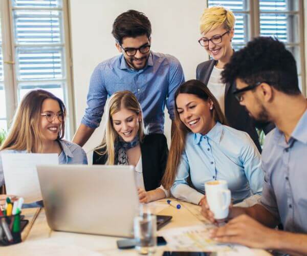 Employees sitting in front of a computer