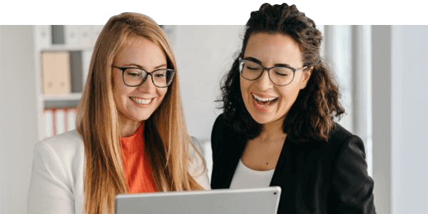 Two employees looking at a computer screen