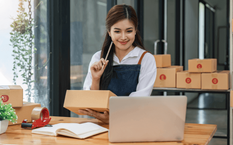 Small business employee packing boxes