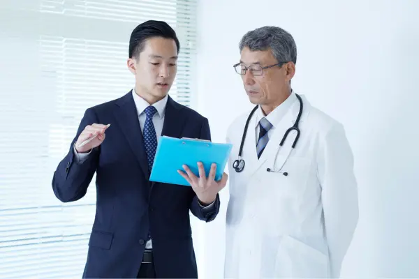 Retail workers shaking hands after sale